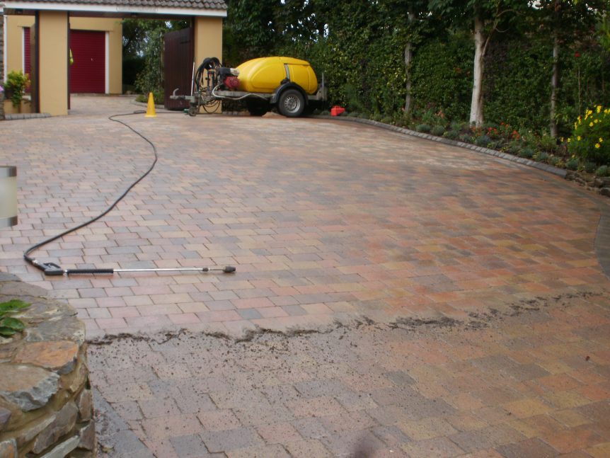 Pressure washing cracked concrete to bring out its color by Mark's Cleaning and Restoration